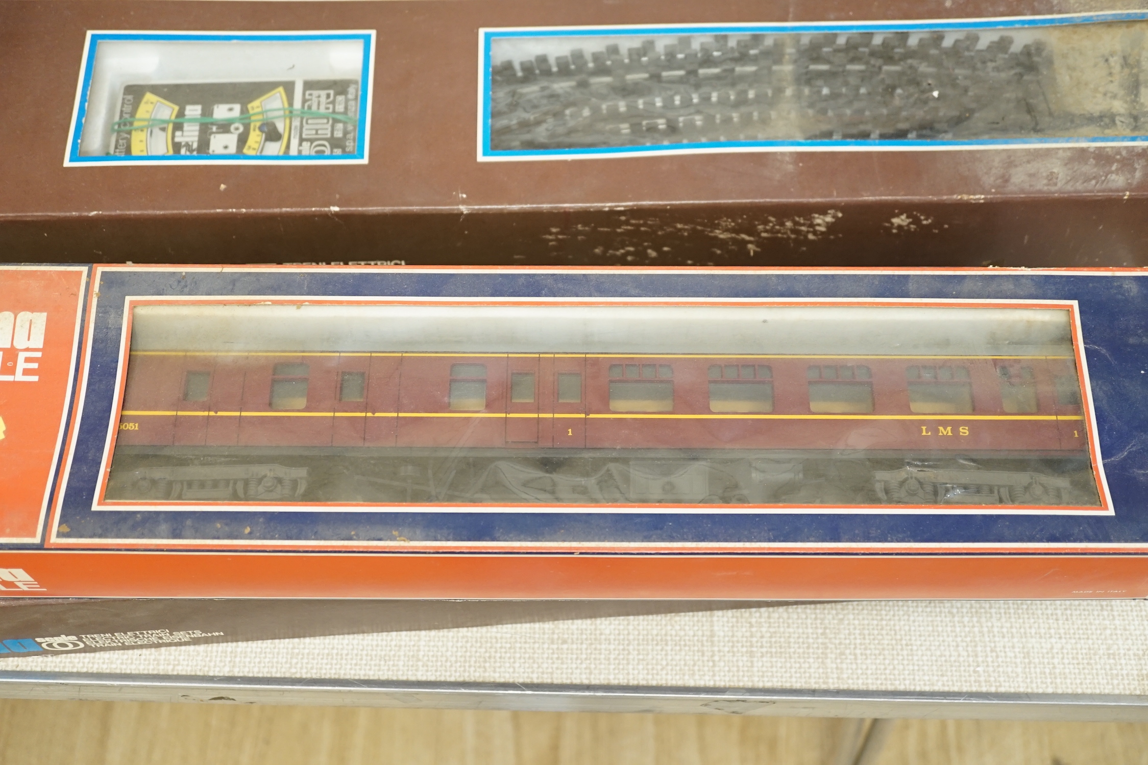 A Lima 0 gauge battery operated train set, together with two additional boxed coaches and a boxed container wagon